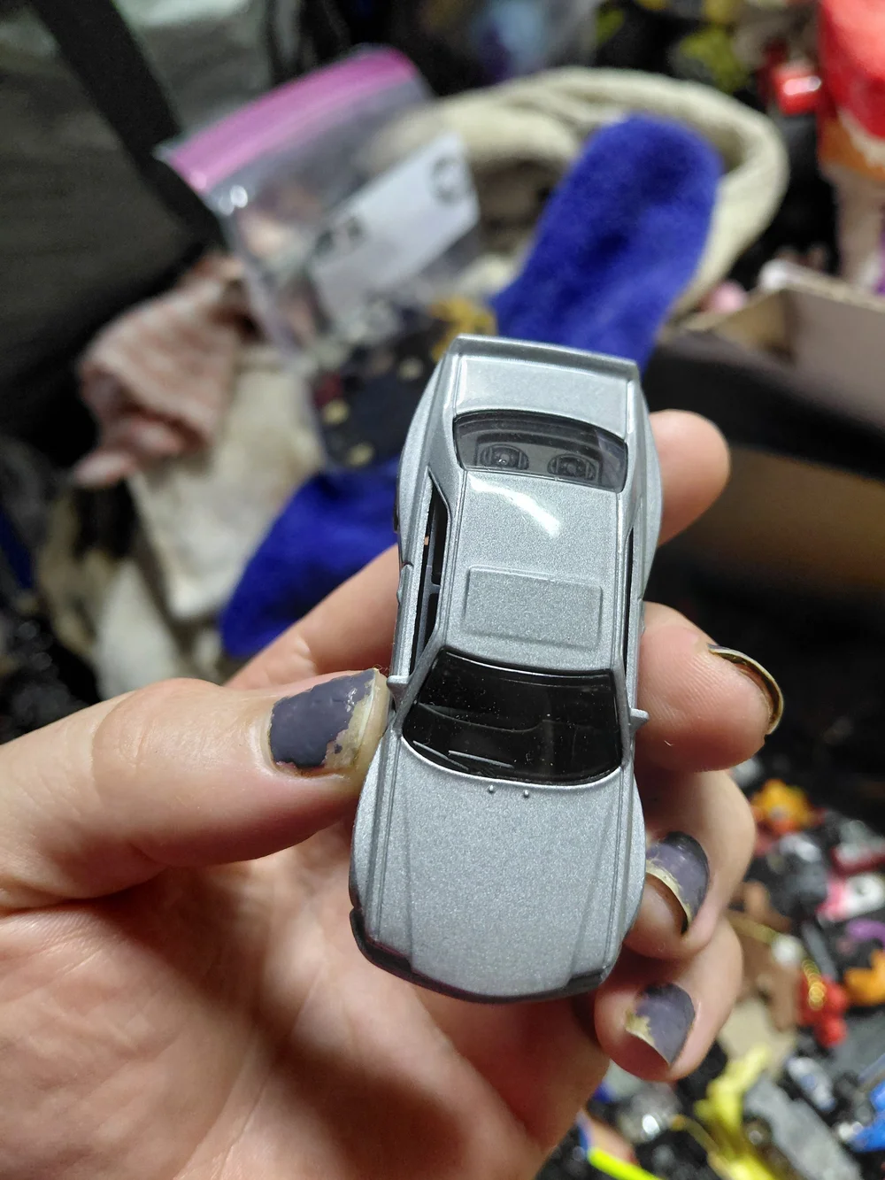 1:64 scale Hot Wheels '89 Mercedes-Benz 560 SEC AMG die-cast toy car.